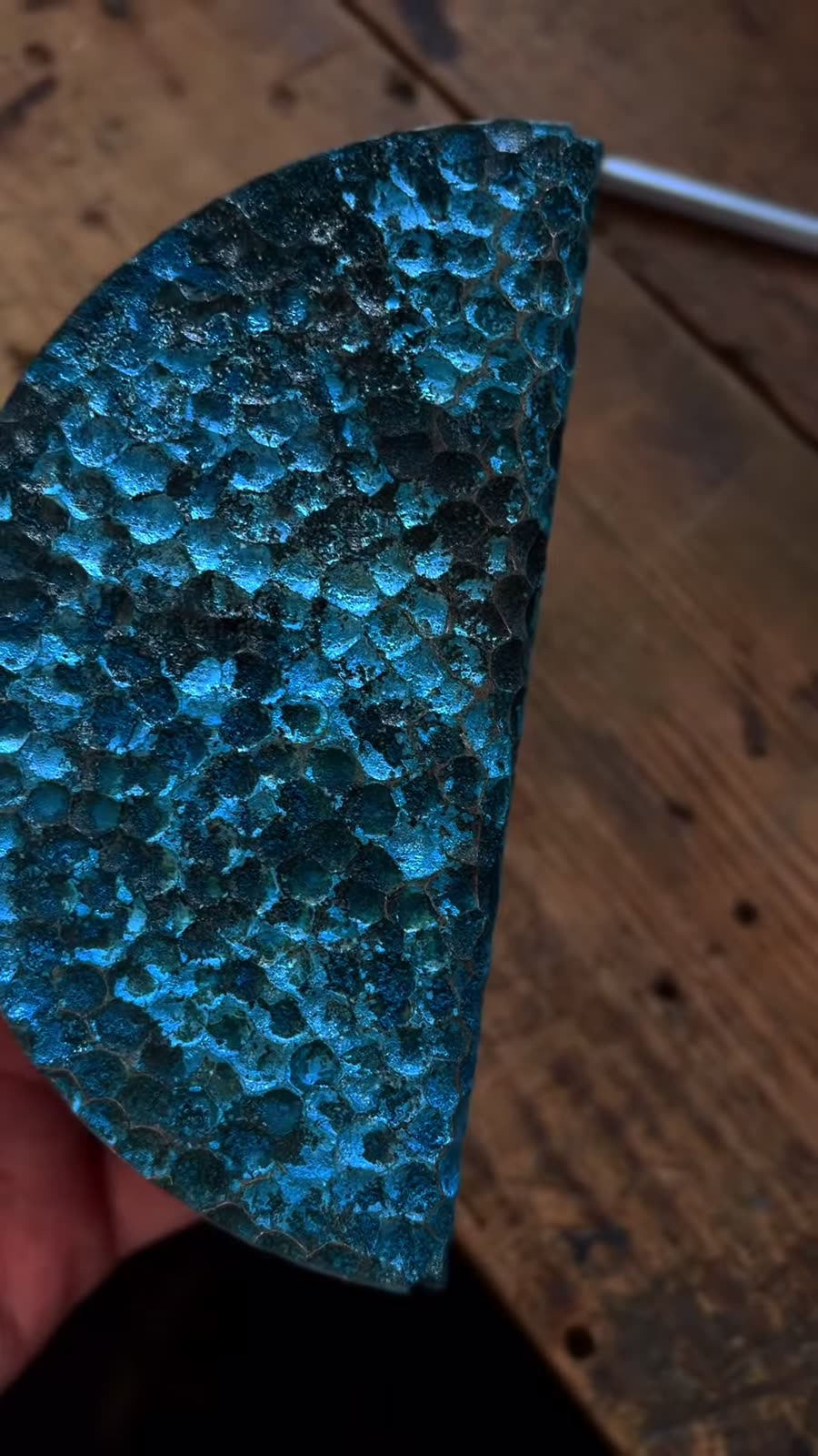 Bright blue patina on a textured copper panel