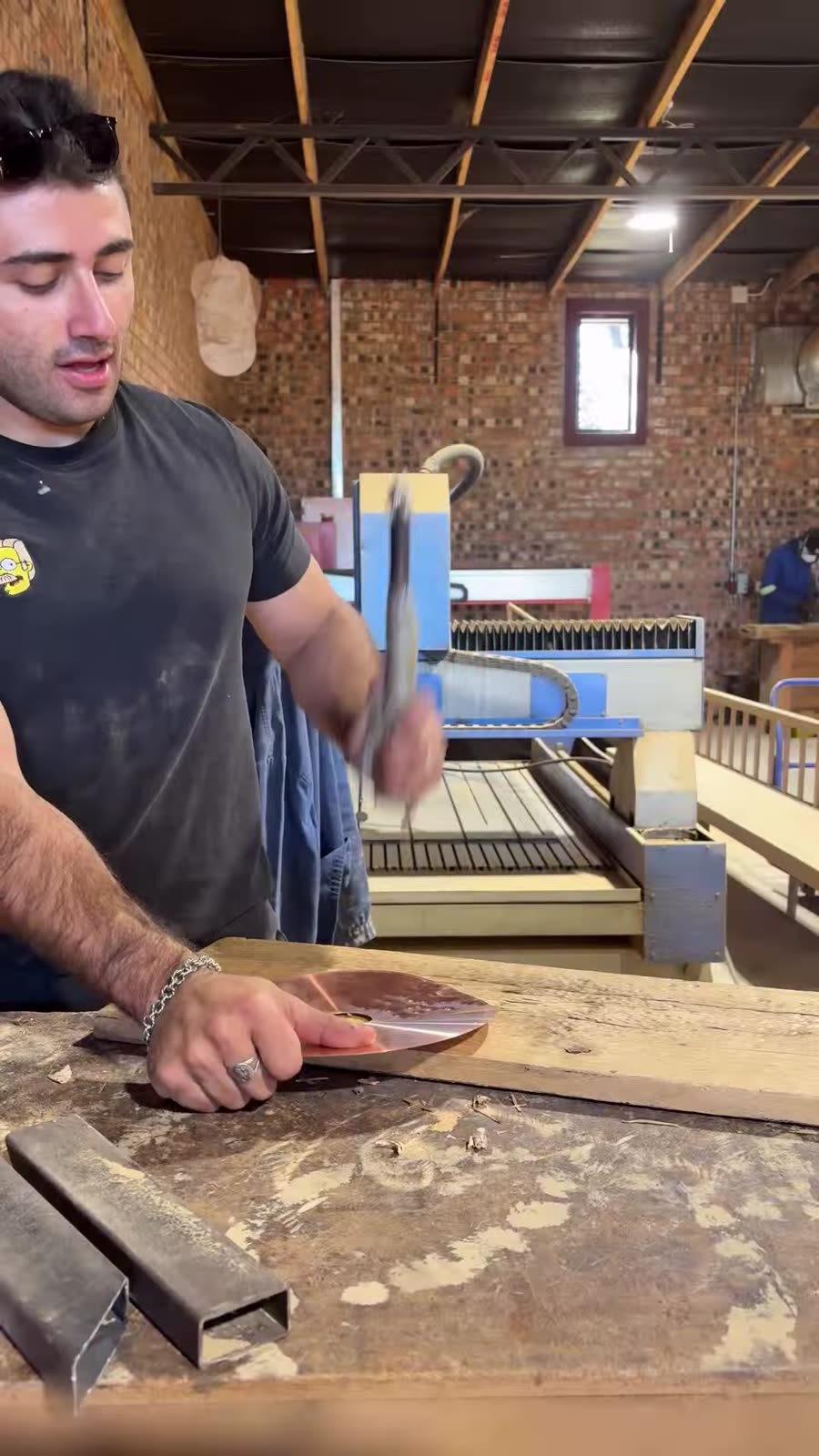 Justin working at a bench in the workshop